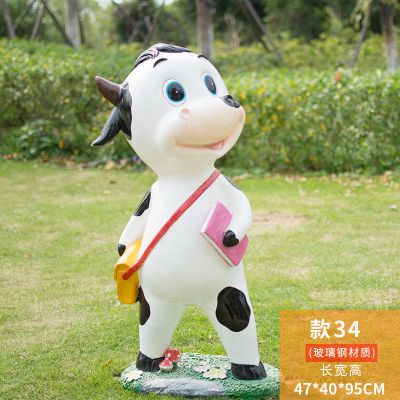 幼兒園一只背書包拿書的玻璃鋼牛雕塑